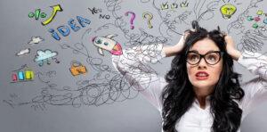 Woman pulling at her hair. She is overwhelmed.