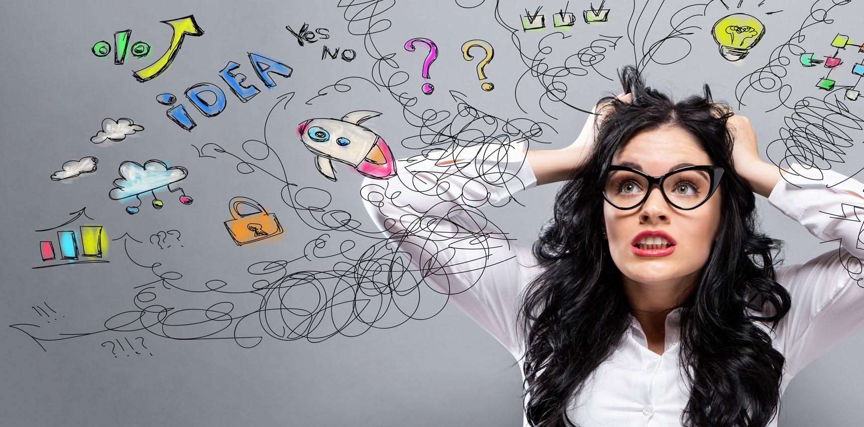 Woman pulling at her hair. She is overwhelmed.