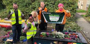 Group Pic of volunteers with the planters they have installed at Orton Malbourne