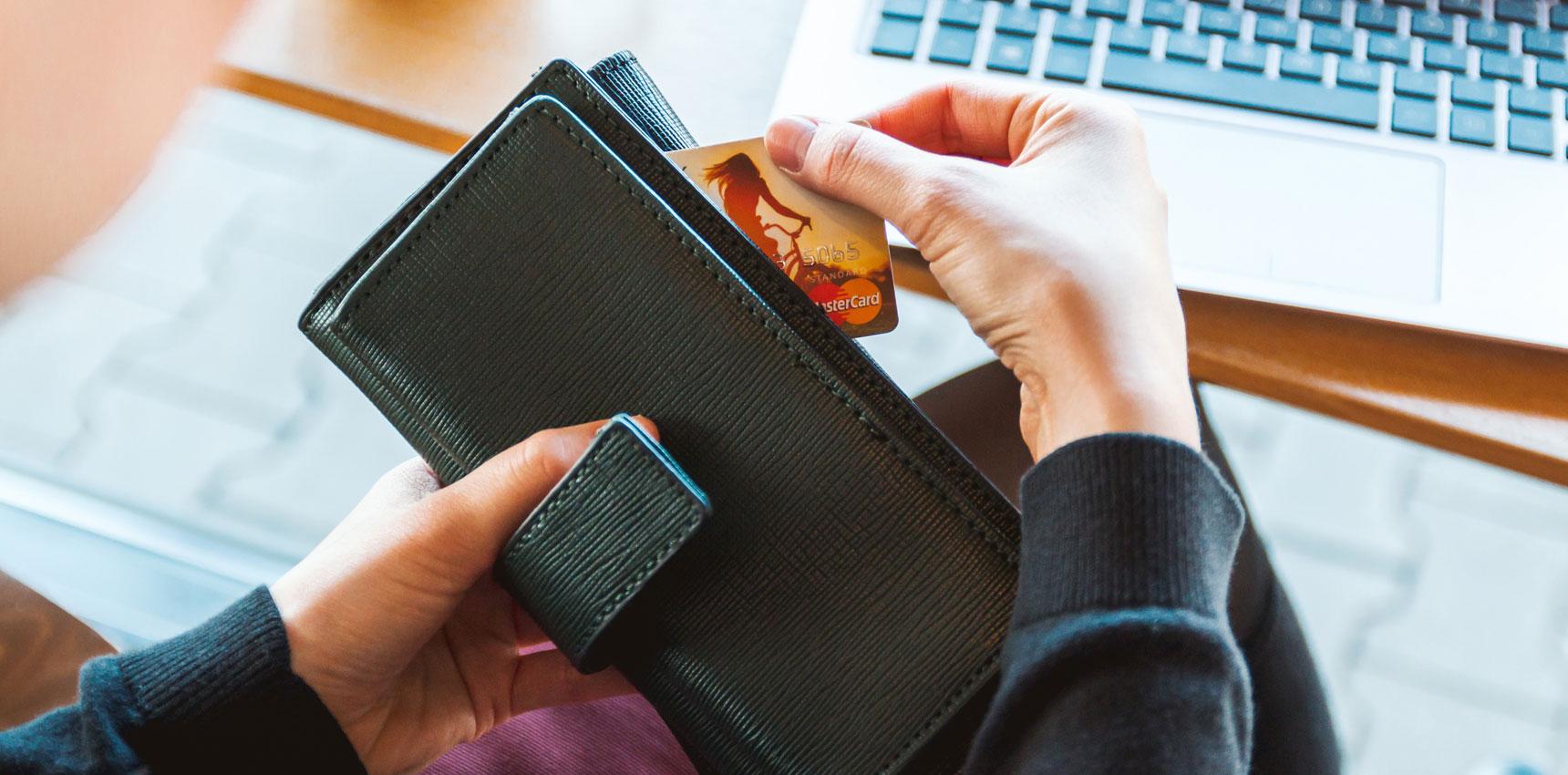 A person pulling out cash from a purse